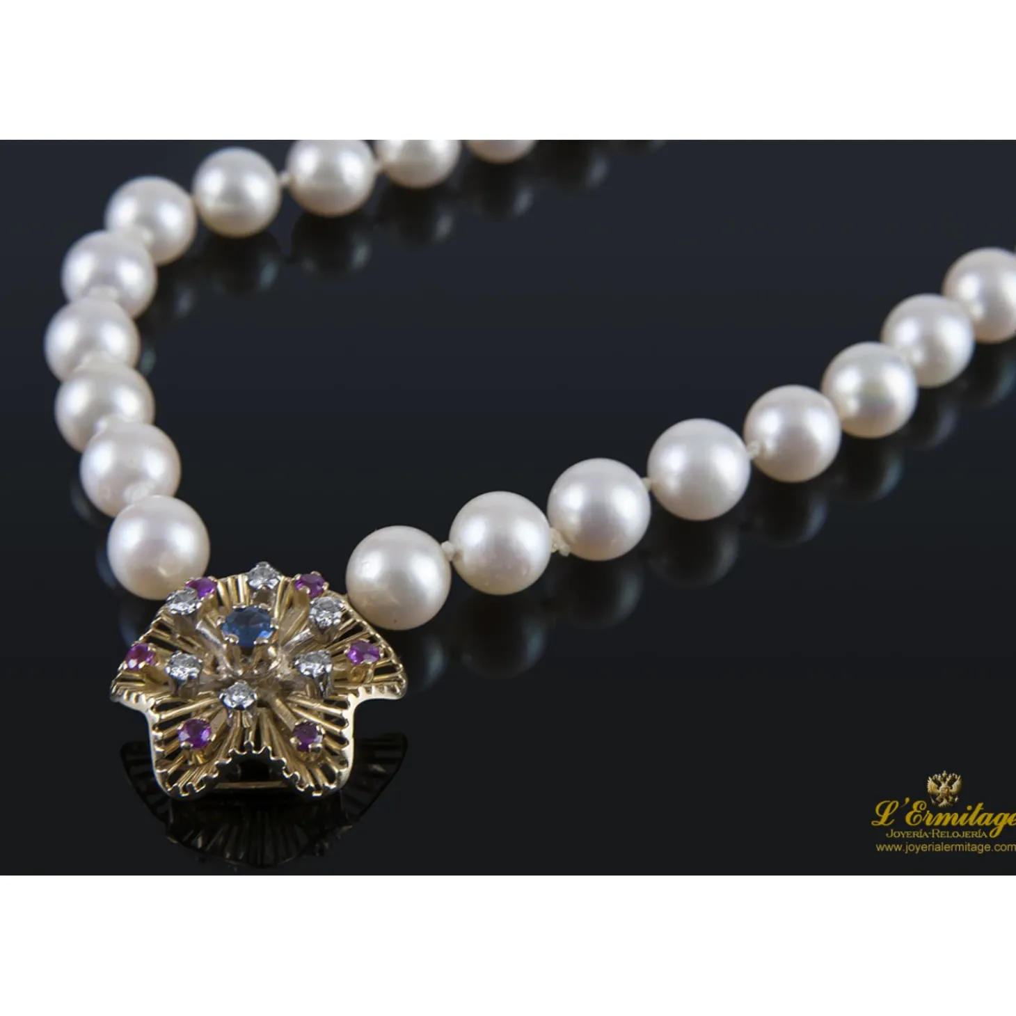 PULSERAS Pulsera de perlas con cierre en oro amarillo con forma de flor.