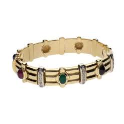PULSERAS Pulsera rígida en oro amarillo con zafiros, rubíes, esmeraldas y brillantes.